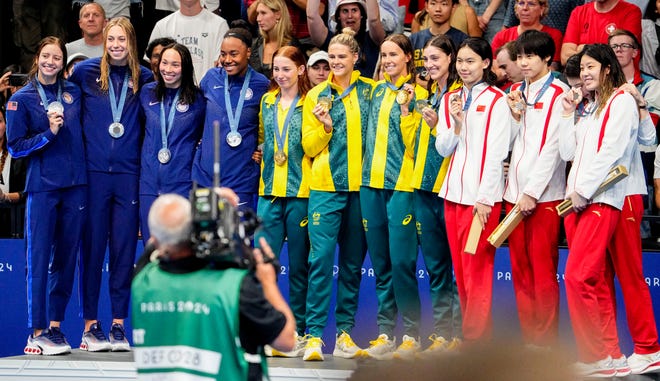 USA, Australia and China in the women’s 4 x 100-meter freestyle relay medal ceremony during the Paris 2024 Olympic Summer Games at Paris La Défense Arena.